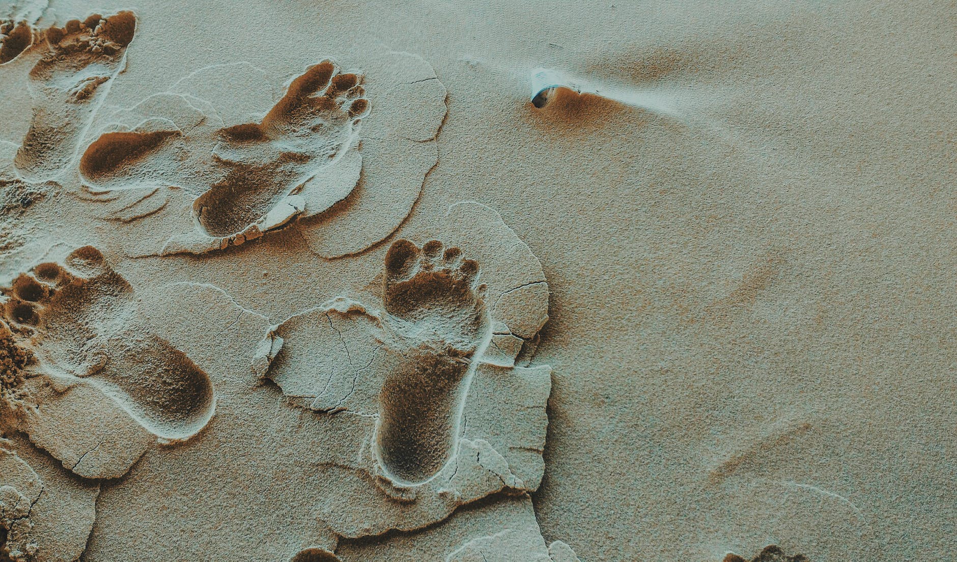 person foot prints on sands photo